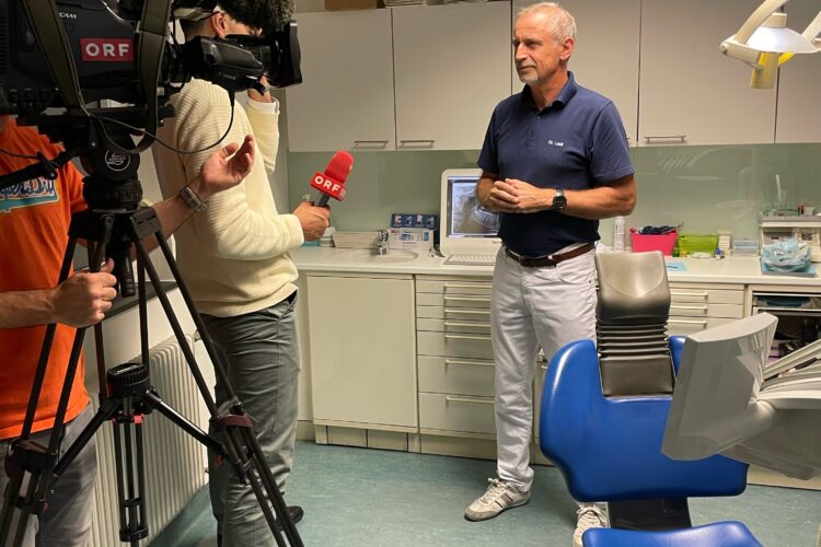 Dr Julian Leidl spricht mit einem Journalisten von ORF Burgenland im Bildvordergrund eine Fernsehkamera